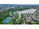 Aerial view showcasing the community, lake, clubhouse, and tennis courts at 6854 Remington View Ct, Orlando, FL 32829