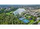 Beautiful aerial view of the tennis courts, lake, and pool at 6854 Remington View Ct, Orlando, FL 32829