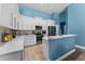Bright kitchen with white cabinets, quartz counters, stainless steel appliances and mosaic backsplash, plus a breakfast bar at 6854 Remington View Ct, Orlando, FL 32829