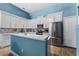 Well-lit kitchen featuring white cabinets, stainless steel appliances, quartz counters, and a mosaic backsplash at 6854 Remington View Ct, Orlando, FL 32829