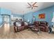 Spacious living room with hardwood floors, ceiling fan, and view of the modern kitchen at 6854 Remington View Ct, Orlando, FL 32829