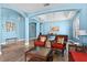 Living room featuring stylish rattan furniture, beautiful art, and wood-style flooring at 6854 Remington View Ct, Orlando, FL 32829