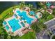 Aerial view of a community pool area with multiple pools, water features, and ample lounging space by the water at 6854 Remington View Ct, Orlando, FL 32829