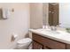 Well-lit bathroom with a vanity, toilet, and a shower with neutral tones for a clean and functional space at 7407 Ripplepointe Way, Windermere, FL 34786