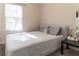 Well-lit bedroom with comfortable bed, side table, and neutral tones for a relaxing retreat at 7407 Ripplepointe Way, Windermere, FL 34786