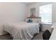 Cozy bedroom with neutral tones, a comfortable bed, and a window providing natural light at 7407 Ripplepointe Way, Windermere, FL 34786