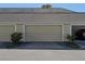 Attached garage with neutral door, manicured landscaping, and ample parking space at 7407 Ripplepointe Way, Windermere, FL 34786