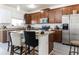 Open kitchen with stainless steel appliances, granite countertops, and a center island with seating at 7407 Ripplepointe Way, Windermere, FL 34786