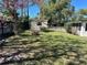 Backyard with a small storage shed and a fire pit, creating an inviting outdoor space for entertaining at 818 Logan Dr, Longwood, FL 32750