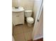 Cozy half-bathroom featuring a toilet and vanity, with tile floors and panel walls at 818 Logan Dr, Longwood, FL 32750