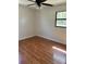 Cozy bedroom featuring wood laminate flooring, ceiling fan, and window at 818 Logan Dr, Longwood, FL 32750