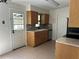 Bright kitchen with stainless steel appliances, tile countertops, and wood cabinets at 818 Logan Dr, Longwood, FL 32750