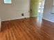 Living room featuring wood-look flooring, with a view of the front door and front yard at 818 Logan Dr, Longwood, FL 32750