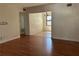 Bright living room with wood laminate floors leading into dining area at 818 Logan Dr, Longwood, FL 32750