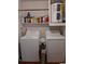 Bright laundry area with new machines, shelving, and ample storage space for cleaning supplies at 824 Town Cir # 101, Maitland, FL 32751