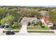 Expansive aerial view of a well-maintained property with mature landscaping and a spacious driveway at 872 High Pointe Cir, Minneola, FL 34715