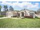 Inviting home showcasing a lush lawn and a welcoming front porch with seating area at 872 High Pointe Cir, Minneola, FL 34715