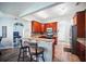 Beautiful kitchen featuring warm-toned cabinets, granite countertops, and stainless steel appliances at 872 High Pointe Cir, Minneola, FL 34715