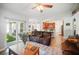 Open-concept living area featuring modern furniture, an adjacent dining area, and a view to the kitchen at 872 High Pointe Cir, Minneola, FL 34715