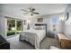 Bright main bedroom features a sliding glass door and plush carpet at 872 High Pointe Cir, Minneola, FL 34715