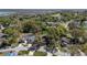 Aerial view of home, located in a community with lakes and mature trees at 8722 Village Green Blvd, Clermont, FL 34711