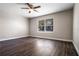 Bedroom featuring neutral walls, wood floors, and a bright window at 8722 Village Green Blvd, Clermont, FL 34711