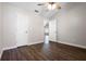 Bedroom featuring neutral walls, wood floors, ceiling fan, and closet at 8722 Village Green Blvd, Clermont, FL 34711