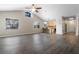 Bright living room with a view of the kitchen, featuring ample natural light and modern flooring at 8722 Village Green Blvd, Clermont, FL 34711