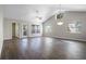 Spacious living room featuring high ceilings, modern lighting, and beautiful wood-look flooring at 8722 Village Green Blvd, Clermont, FL 34711