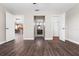 Wood floors connecting living spaces, showcasing open floor plan and neutral colors at 8722 Village Green Blvd, Clermont, FL 34711