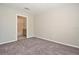 Neutral bedroom with plush carpeting and an open doorway leading to an en-suite bathroom with a tub at 9093 Lee Vista Blvd # 905, Orlando, FL 32829