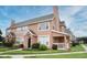 View of a well-maintained two-story townhouse with lush lawn and manicured landscaping on a sunny day at 9093 Lee Vista Blvd # 905, Orlando, FL 32829