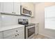 Kitchen showcasing stainless steel appliances, white countertops, subway tile backsplash, and light gray shaker style cabinets at 9093 Lee Vista Blvd # 905, Orlando, FL 32829