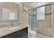 Modern bathroom featuring a sleek vanity, glass-enclosed shower, and elegant finishes at 929 Arbormoor Pl, Lake Mary, FL 32746