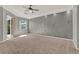 Bedroom with neutral carpet, textured walls, ceiling fan, and access to outdoor patio at 929 Arbormoor Pl, Lake Mary, FL 32746