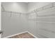 Walk-in closet featuring open wire shelving and carpet flooring at 929 Arbormoor Pl, Lake Mary, FL 32746