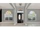 Inviting entryway featuring an arched front door, windows, and columns at 929 Arbormoor Pl, Lake Mary, FL 32746