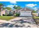 Beautiful home featuring a brick driveway, manicured landscaping, and a two-car garage at 929 Arbormoor Pl, Lake Mary, FL 32746