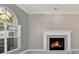 Cozy living room featuring a fireplace with mantel and large window with natural light at 929 Arbormoor Pl, Lake Mary, FL 32746