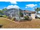 Exterior view of a screened-in pool area with lush foliage around its perimeter at 929 Arbormoor Pl, Lake Mary, FL 32746