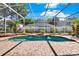 Inviting screened-in pool area with a spa, brick pavers, and lush landscaping, creating a serene outdoor oasis at 929 Arbormoor Pl, Lake Mary, FL 32746