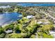 Aerial view of a lakeside home with a pool, lush greenery, and a private dock at 9744 Cub Cv, Apopka, FL 32703