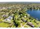 Expansive aerial view showcasing lush landscaping, waterfront access, and neighborhood homes at 9744 Cub Cv, Apopka, FL 32703