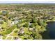 Stunning aerial view showcasing the property's expansive lot with mature trees and proximity to a serene lake at 9744 Cub Cv, Apopka, FL 32703