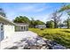 Spacious backyard featuring a patio, a large grassy area, mature trees, and a storage shed at 9744 Cub Cv, Apopka, FL 32703