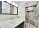 Bathroom featuring a tiled shower and vanity with marble countertop and black cabinetry at 9744 Cub Cv, Apopka, FL 32703