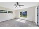 A bedroom features carpet flooring, natural light, and a ceiling fan at 9744 Cub Cv, Apopka, FL 32703