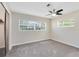 Neutral bedroom featuring carpet floors, ceiling fan, and bright windows with blinds at 9744 Cub Cv, Apopka, FL 32703