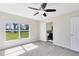 A bedroom featuring carpet flooring, a ceiling fan, and natural light at 9744 Cub Cv, Apopka, FL 32703