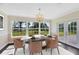 Bright dining room with marble table and large windows offering serene views at 9744 Cub Cv, Apopka, FL 32703